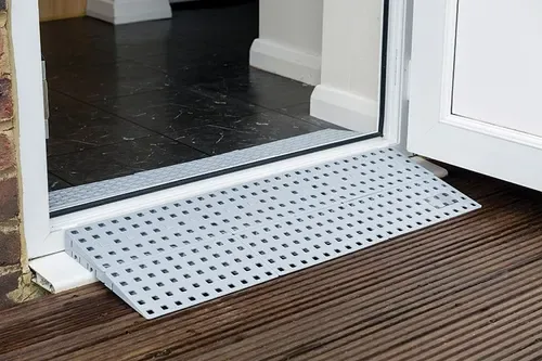 Threshold ramp fitted at a patio door, bridging the step from decking to floor